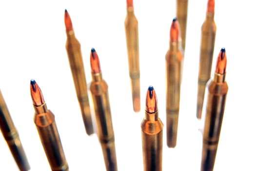 ammunition all in a cluster on a white background with reflections