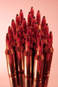 ammunition all in a cluster on a pink background