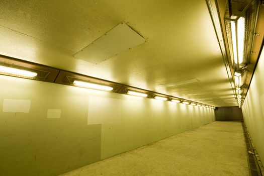 long tunnel with lamps and nobody walking