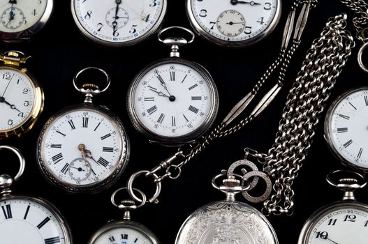 Background of cracked silver pocket watch on black