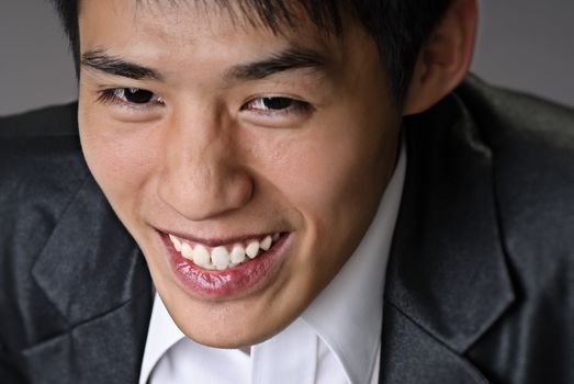 Smiling businessman face, closeup portrait with happy expression.