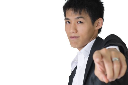 Confident business man pointing out towards you on white background with copyspace.