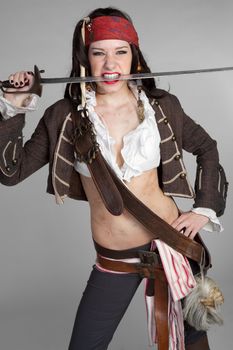 Sexy pirate woman biting sword