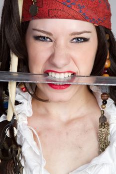 Female pirate holding knife in teeth