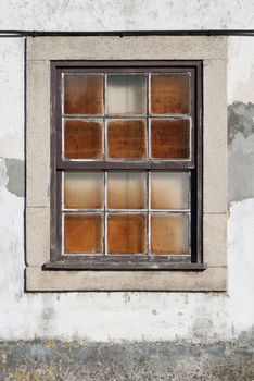 A closed old window with dirty glass.