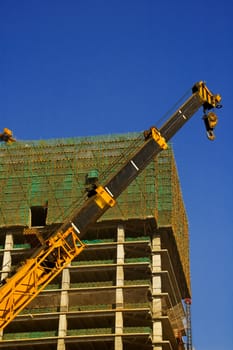 office skyscraper building on construction with big crane