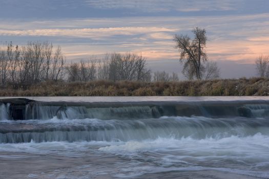 dam on the South Platte River in north eastern Colorado naer Greeley providing water for farmland irrigation, late fall, dusk