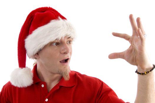 christmas hat wearing male looking at palm on an isolated white background
