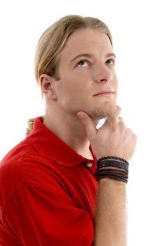 smart young man thinking and looking sideways against white background