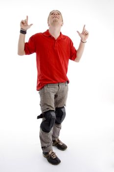 young american male with pointing fingers and looking upwards against white background