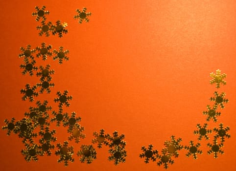 lots of golden snowflakes on red paper