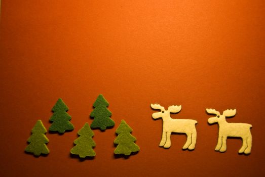 christmas trees and two reindeer on red paper