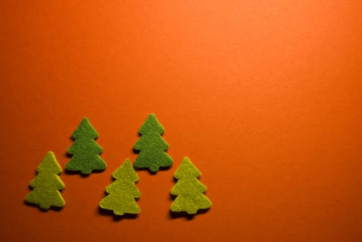 five little christmas trees on red paper