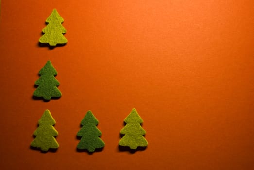 five little christmas trees on red paper