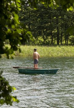 angler on boat on lake