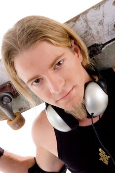 close up view of handsome guy with skateboard on an isolated background