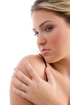 close up view of young pretty female looking at camera against white background