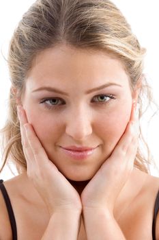 close up view of young pretty female looking at camera against white background