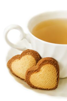 Cup of green tea and heart shaped biscuits