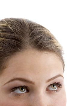 eyes of young woman looking upward against white background