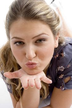 woman showing kissing gesture against white background
