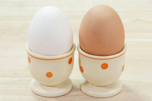 White and brown egg in eggcups