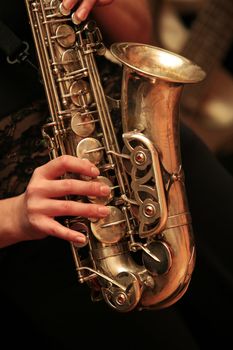 Saxophone player on dark background.