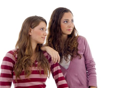 young sisters looking sideways on an isolated background