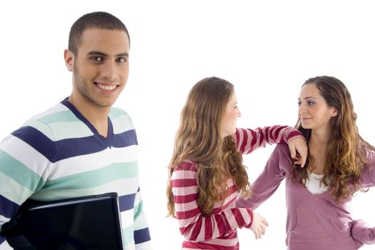 two girls holding to each other and guy looking at camera against white background