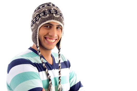 smiling boy covering his head with woolen cap on an isolated white background