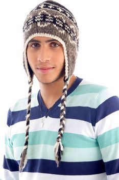 portrait of young boy covering his head with woolen cap on an isolated white background