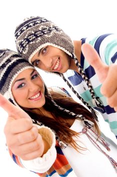 cute couple wearing warm cap showing thumbs up with white background