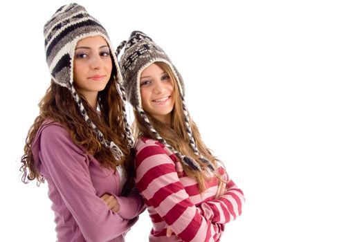 two young friends wearing woolen cap and looking at camera on an isolated white background