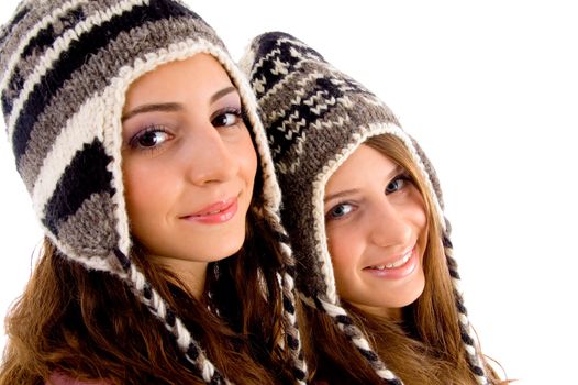 close up view of teens friends smiling and looking at camera against white background