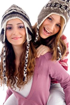 two girls showing happiness together on an isolated white background