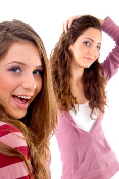 two girls showing happiness together on an isolated white background
