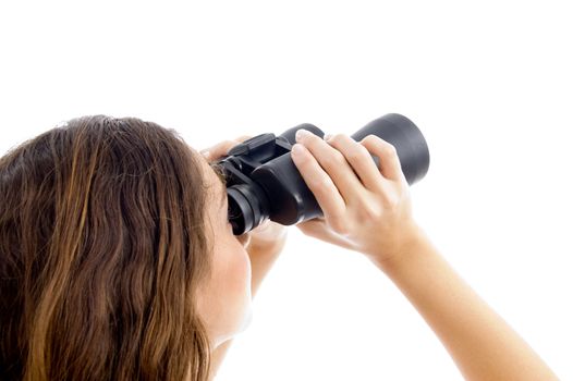 female watching through binocular against white background