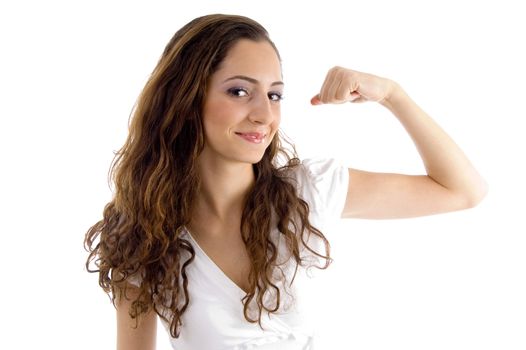 attractive female showing muscles on an isolated white background