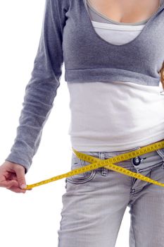 female measuring her waist with tape on an isolated white background