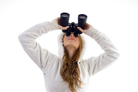 female watching upward through binocular with white background