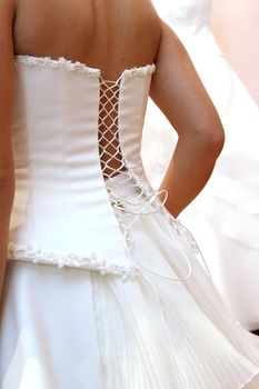 woman puts on beautiful white wedding dress