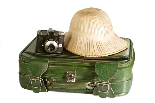 Suitcase with safari hat and old camera - isolated on white background