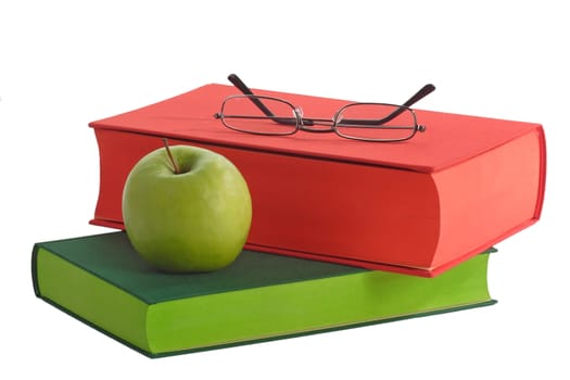 Books with green apple an reading glasses - isolated on white background