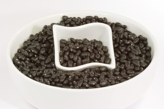 Black Beans in a white bowl on bright background