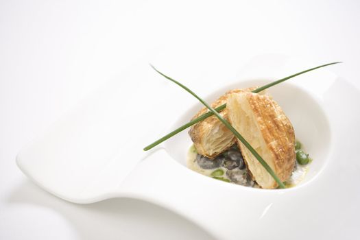 Escargot en croute with butter and fava beans.