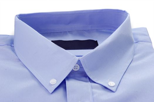 Detail of blue shirt with collar and buttons.
