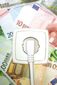 Plugged power cable isolated on a money background.
