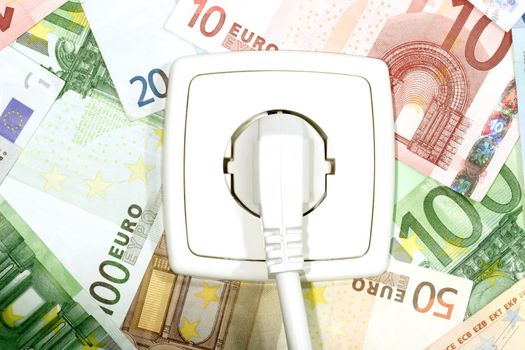 Plugged power cable isolated on a money background.