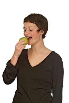 A pretty young woman  eats a green apple
