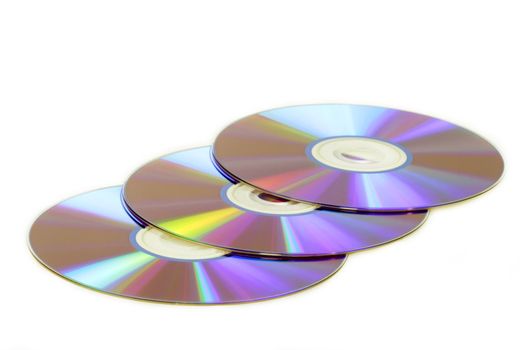 Three shiny DVDs on white background